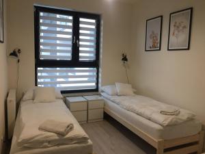 Posteľ alebo postele v izbe v ubytovaní Apartament Kraków Arena No. 100
