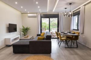 a living room with a couch and a table at Poseidon close to the beach in Agios Nikolaos
