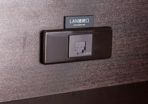 a lightswitch on the side of a wall at APA Hotel Hakata Ekimae 2Chome in Fukuoka