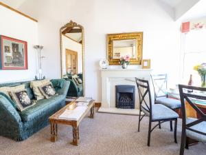 a living room with a couch and a fireplace at Bay View Apartment in Porthmadog