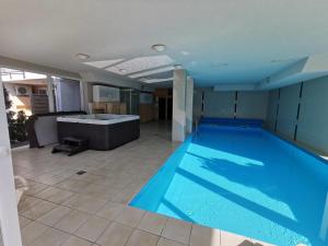 a large swimming pool in a large room with at Promenade Apartman in Siófok