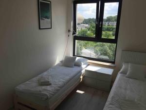 Posteľ alebo postele v izbe v ubytovaní Apartament Kraków Arena No. 100
