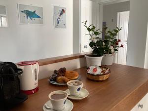 a table with two cups of coffee and pastries on it at Guest House Scilla e Cariddi in Tropea