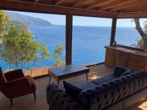 a living room with a view of the ocean at Kabak Ütopya Suites in Faralya