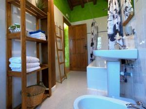 a bathroom with a sink and a toilet and a mirror at Molino del Corregidor in San Román de Cameros +29 photos