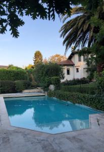 a swimming pool in front of a house at Appartement Ranavalo Pays Basque in Anglet