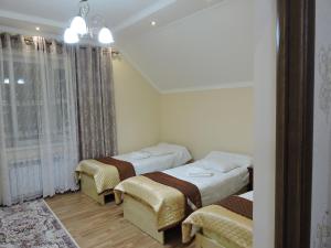 Postel nebo postele na pokoji v ubytování Guest House Ulukbek
