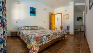 a bedroom with a bed and a table and chairs at CASANTILVIA heated pool paradise in Adeje