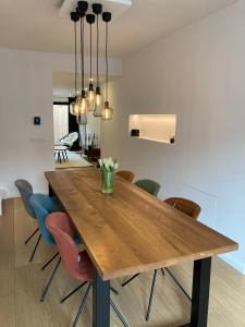 a dining room with a wooden table and chairs at Semarane in Knokke-Heist