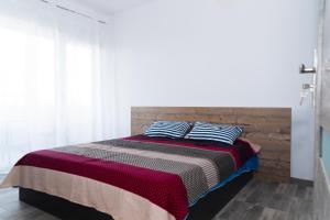 a bed with two pillows on it in a bedroom at Apartament West in Oradea