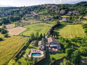 an aerial view of a house on a hill at I Ginepri exclusive CountryHouse, 15pax, private pool, Aulla in Serricciolo