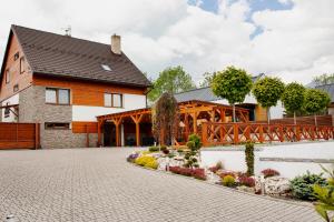 a house with a brick driveway and a bridge at Chalet Nova Lesna Mountain View in Nová Lesná