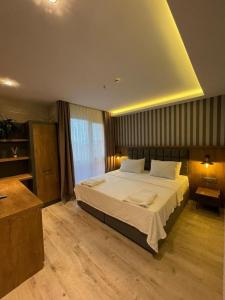 a bedroom with a large bed in a room at DEDEHAN GOLDEN PLAZA in Trabzon