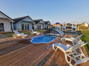 a deck with lounge chairs and a swimming pool at BobolinLove in Bobolin