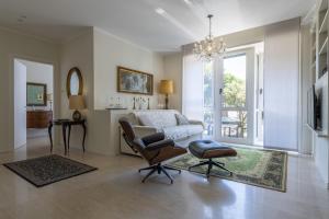 a living room with a couch and a chair at Casa Lazzarini luxury apartment in Pesaro