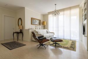 a bedroom with a bed and a chair and a table at Casa Lazzarini luxury apartment in Pesaro