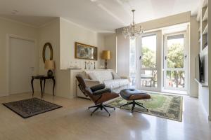 a living room with a bed and a chair at Casa Lazzarini luxury apartment in Pesaro