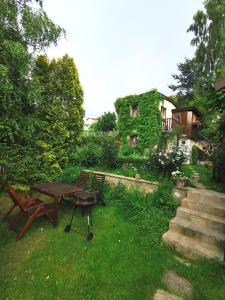 a picnic table and a bench in a yard at Wild Wine House in Gdynia
