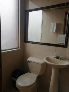a bathroom with a toilet and a sink at Room in Guest room - Comfotable Room in excelent location in Bogotá