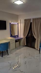 a large room with a desk and a mirror at Augusta Methoni Hotel in Methoni