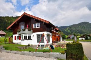 a house with a kite in front of it at Haus im Wäldle in Balderschwang +10 photos