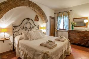 a bedroom with a large bed with towels on it at Il Torrino Country Resort in Montaione