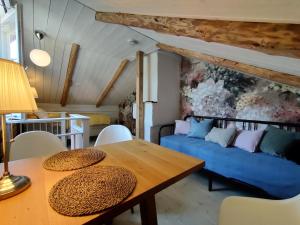 a living room with a blue couch and a table at Villa Reuter in Stormälö
