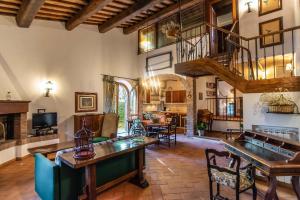a large living room with a table and a staircase at Il Torrino Country Resort in Montaione