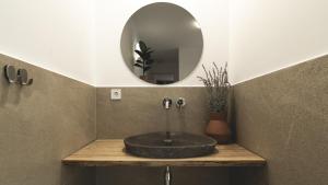 a bathroom with a stone sink and a mirror at La Finca - Saint Vlas in Sveti Vlas