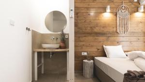 a bedroom with a sink and a bed with a mirror at La Finca - Saint Vlas in Sveti Vlas