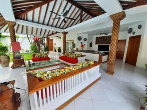 a living room with a couch and a kitchen at Yogyakarta Tropicana Villa in Yogyakarta