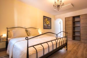 a bedroom with a bed and a chandelier at Vila Radolca apartments and rooms in Radovljica