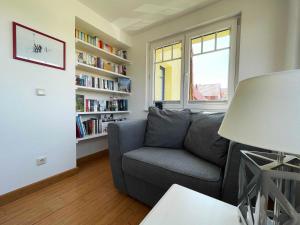 a living room with a couch and a book shelf at FeWo Gretel in Zinnowitz