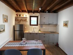 a small kitchen with a table and a sink at Olympus Country House in Kariá