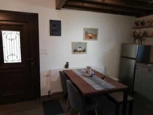 a kitchen with a table and a refrigerator at Olympus Country House in Kariá