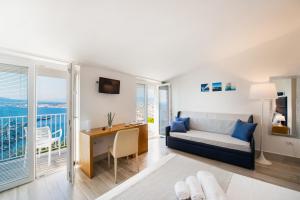a living room with a bed and a desk with a view at Relais Manfredi in Castellammare di Stabia