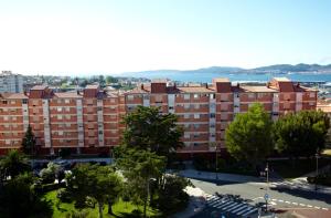 an apartment building with a view of the water at Hotel Coia de Vigo in Vigo