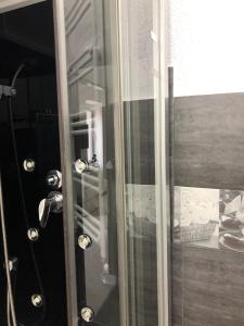 a shower with a glass door with towels at SMART GuestHouse in Oradea +32 photos