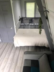 a bedroom with a large bed and a window at Gracelands Glamping in Ballyronan