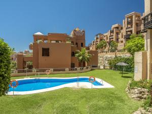 a swimming pool in the yard of a building at 2311-modern apt with sea and pool views in San Luis de Sabinillas