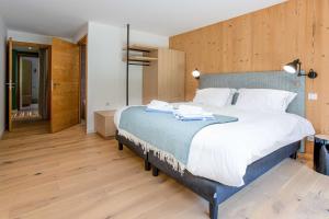 ein großes Schlafzimmer mit großem Bett und Holzböden in der Unterkunft La Cordee 703 Apartment - Chamonix All Year in Chamonix-Mont-Blanc + 33 Fotos