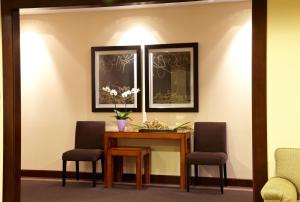 a dining room with a table and two chairs at Hotel Coia de Vigo in Vigo