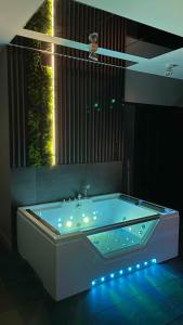a bathroom with a tub with lights in it at MagSpace River View Jacuzzi Apartment in Gdańsk