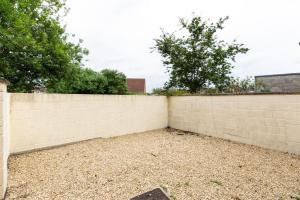 a brick privacy fence with trees in the background at Kellaway Avenue I 1 bedroom apartment in Bristol