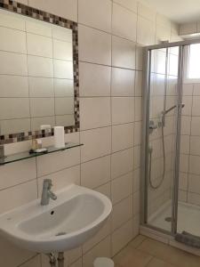 a bathroom with a sink and a shower at Pension N-Ring in Nürburg +25 photos