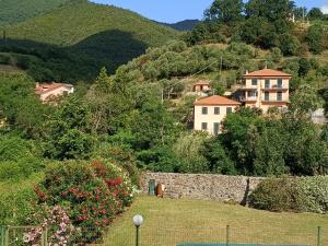 a group of houses on a hill with a stone wall at Da Ange e Bru in Sestri Levante