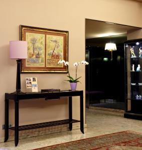 a table in a room with a picture on the wall at Hotel Coia de Vigo in Vigo