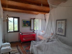 a bedroom with a bed with mosquito net at Ca' Amorino in Galzignano