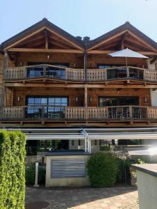 ein großes Holzhaus mit einem großen Balkon in der Unterkunft Avenida Mountain Resort A11 in Kaprun