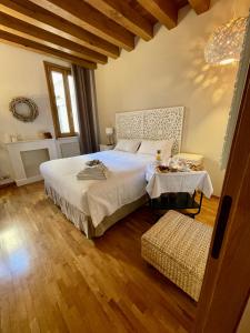 a bedroom with a large bed and a table at Avogari B&B in Treviso